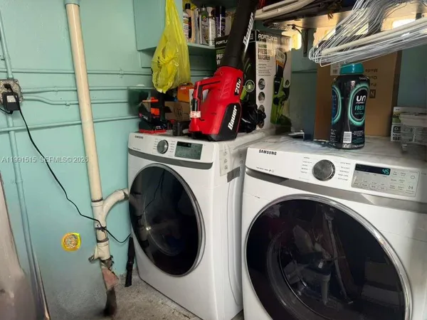 a utility room with dryer washer and other items