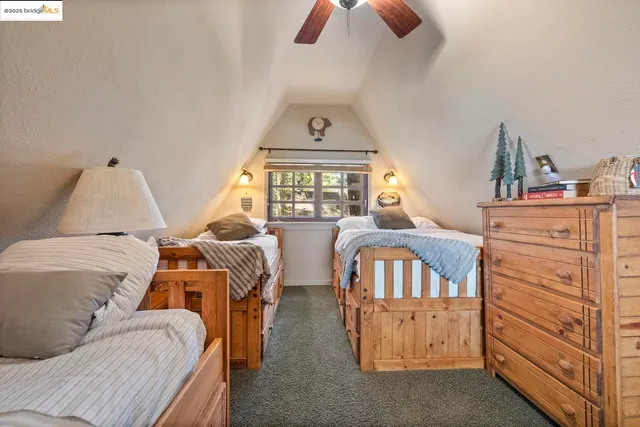 a bedroom with two beds and a window