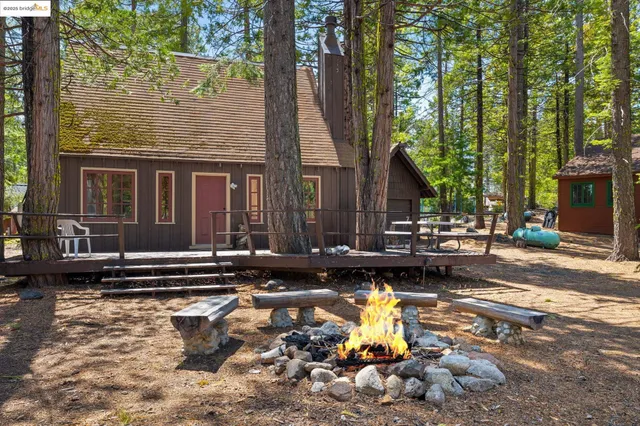 a view of a house with backyard water fountain and sitting area