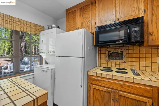 a kitchen with a appliances a sink and a cabinets