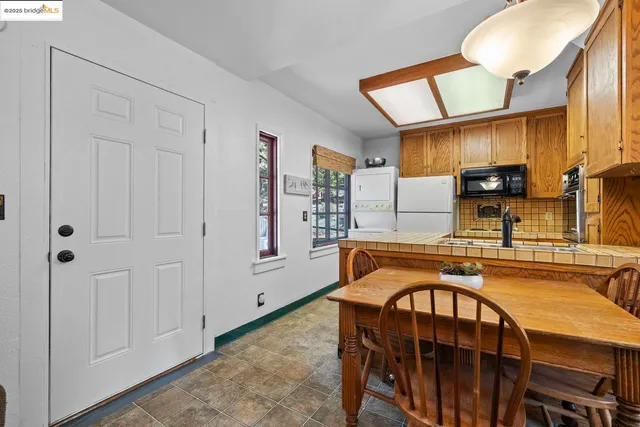 a kitchen with stainless steel appliances granite countertop a sink a stove and cabinets