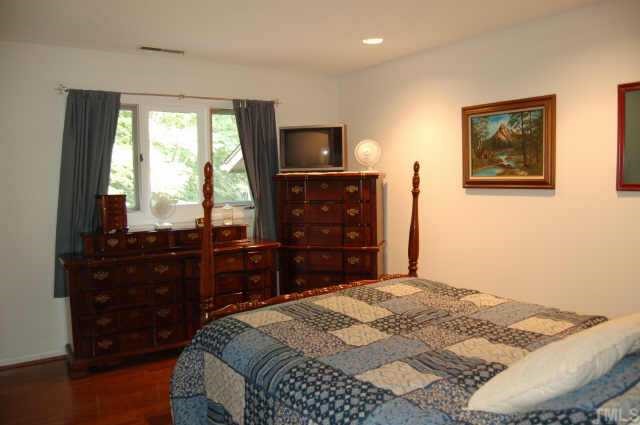 48 Stoneridge Road Durham, NC 27705 - Photo 3 of 8 a bedroom with a bed and a television