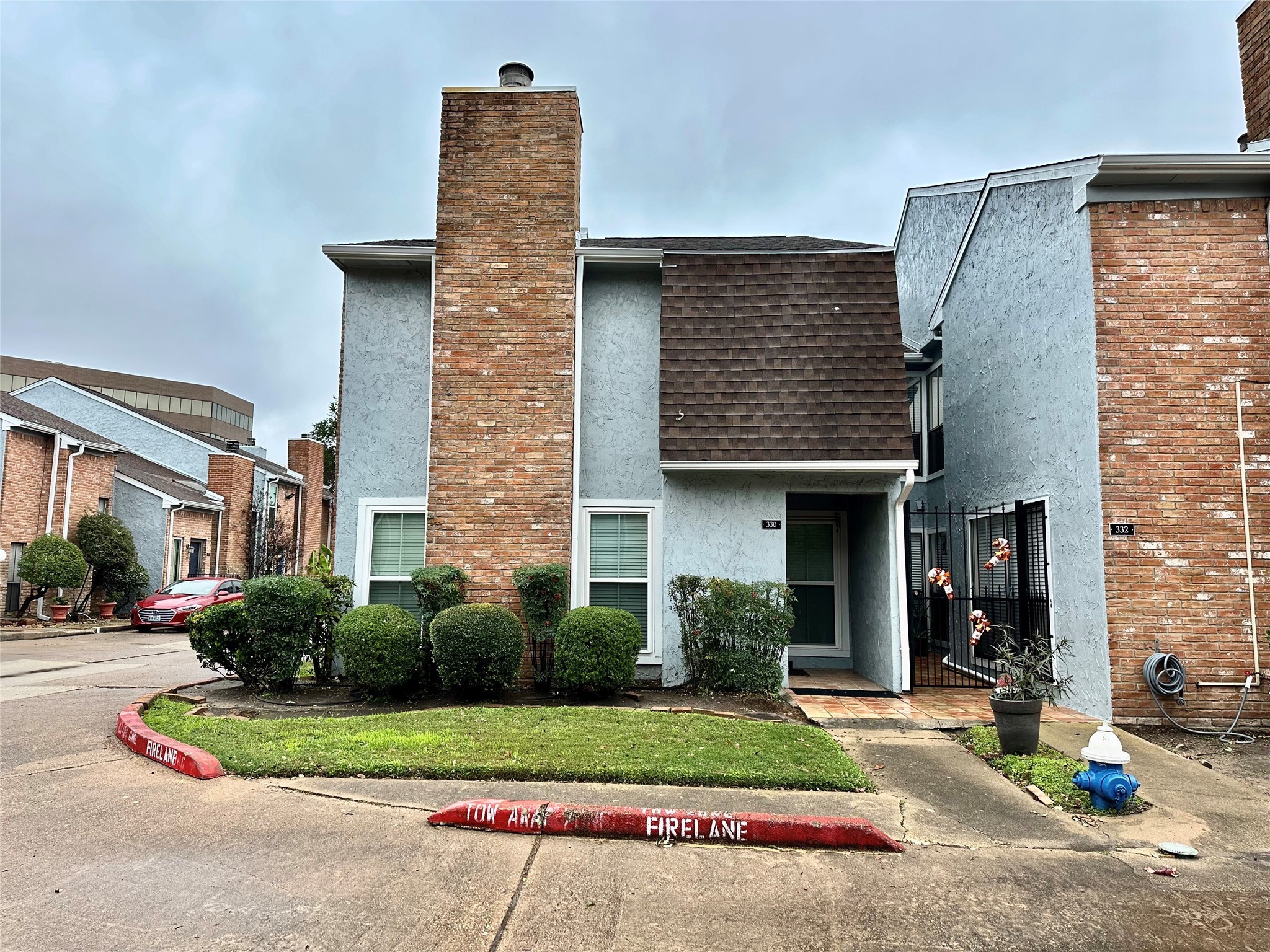 3200 South Gessner Road, Unit 330 Houston, TX 77063 - Photo 2 of 27 a front view of a house with a yard and outdoor seating