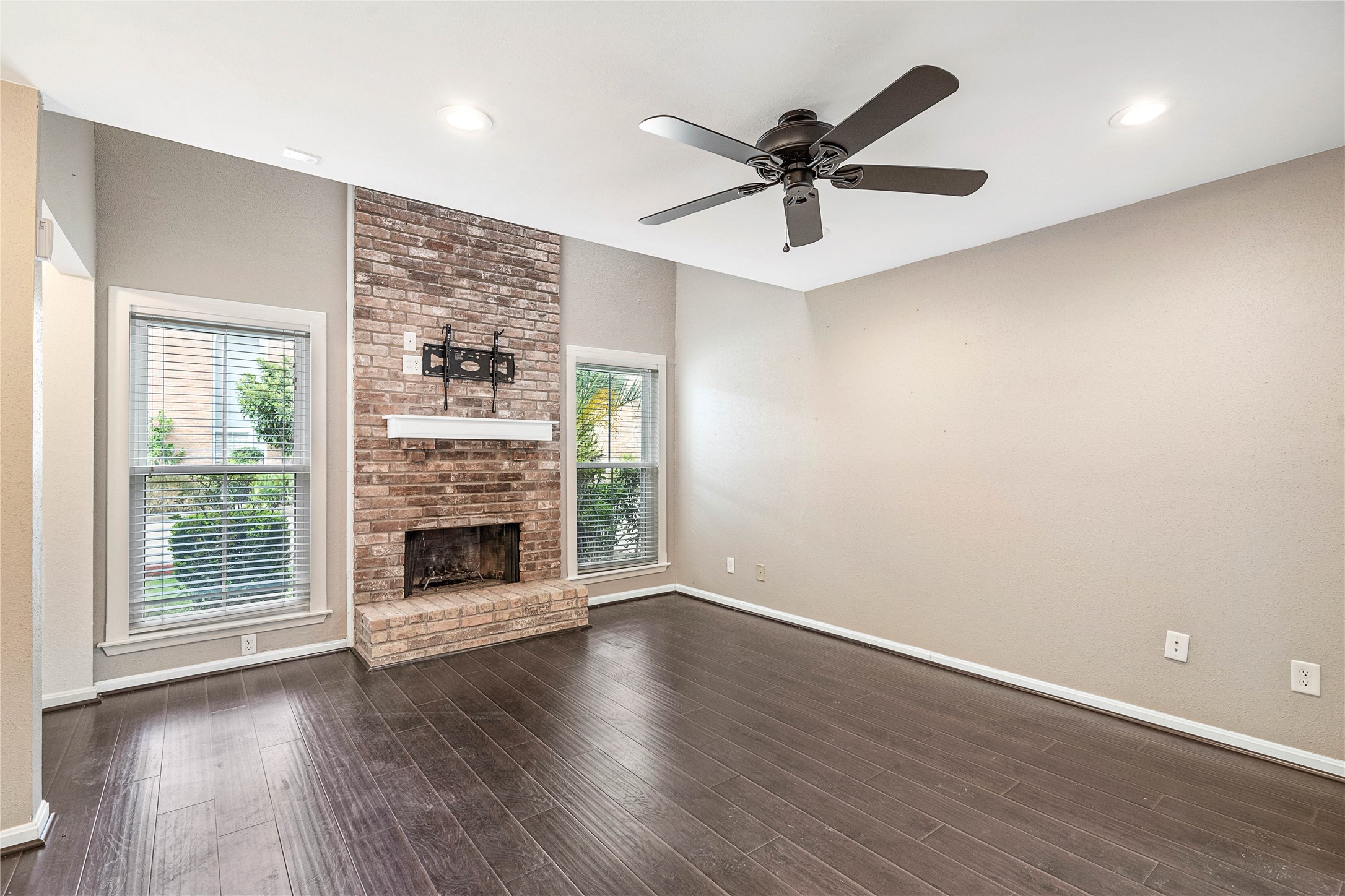 3200 South Gessner Road, Unit 330 Houston, TX 77063 - Photo 8 of 27 an empty room with wooden floor fireplace and windows