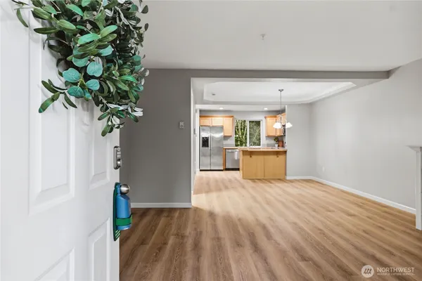 a view of a kitchen with wooden floor and a potted plant