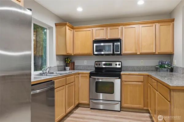 a kitchen with a sink stove and microwave