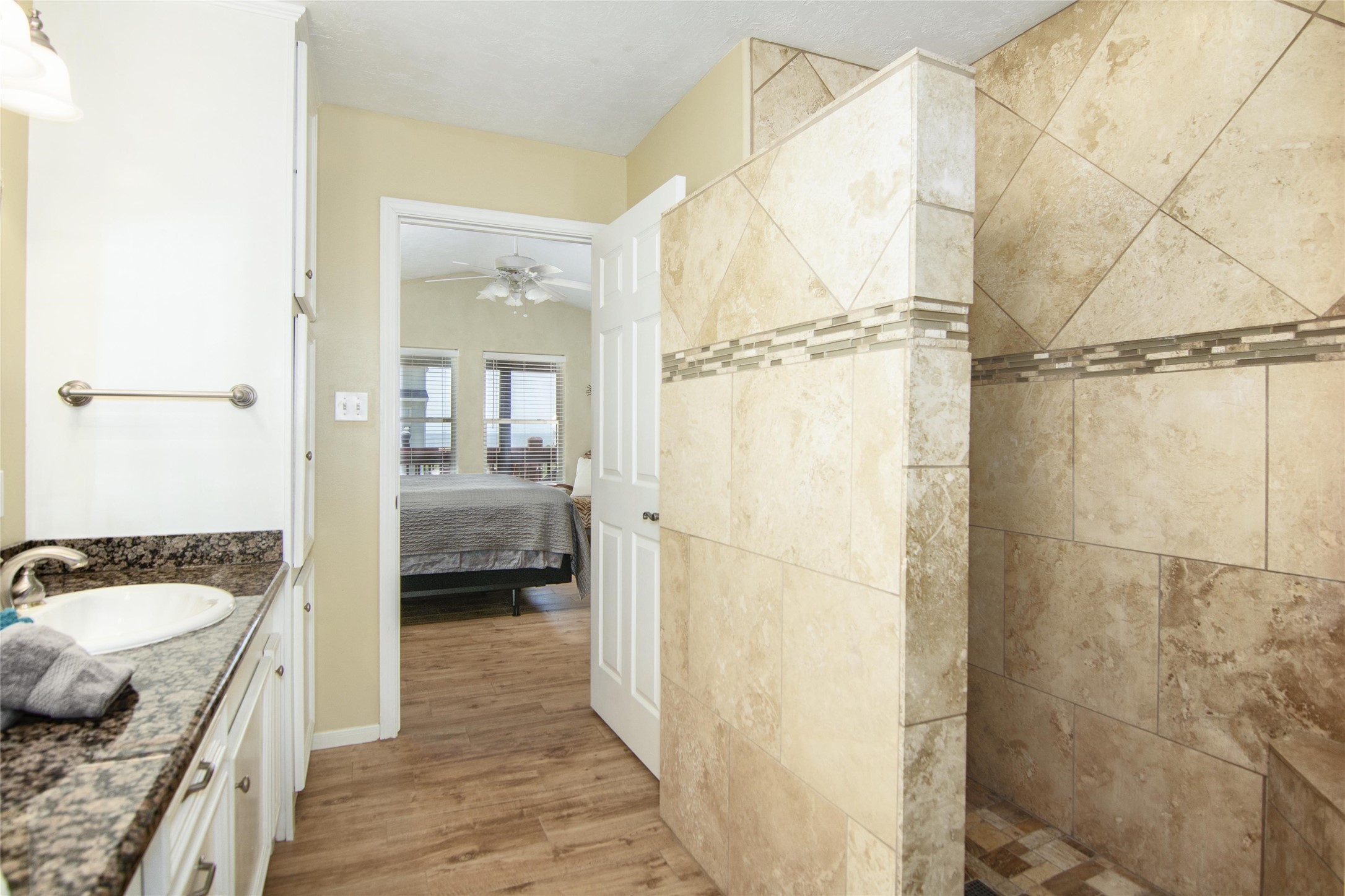 3933 Biscayne Beach Road Port Bolivar, TX 77650 - Photo 21 of 24 a en suite bathroom with a granite countertop sink a mirror and shower