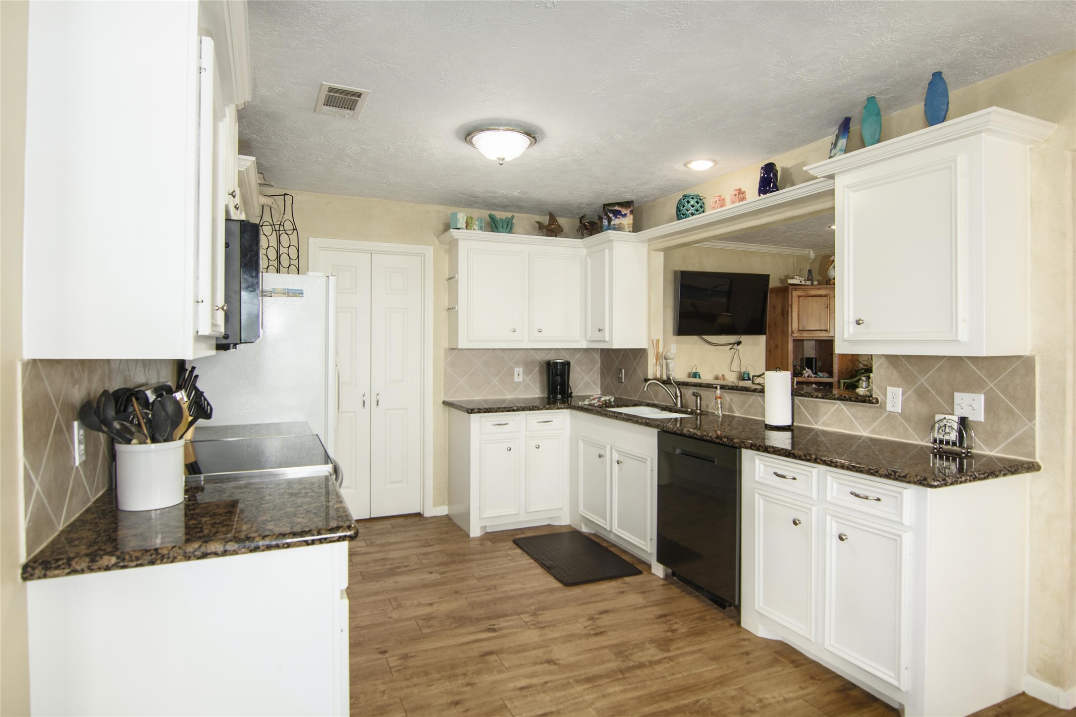 3933 Biscayne Beach Road Port Bolivar, TX 77650 - Photo 4 of 24 a kitchen with a sink stove and cabinets