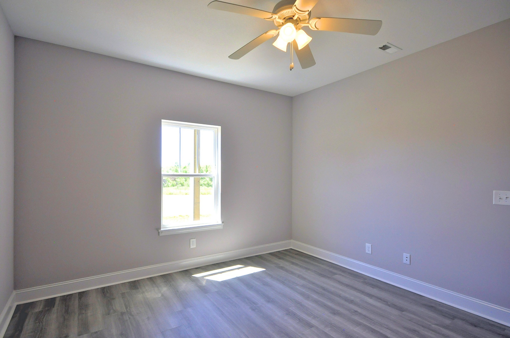179 Bainbridge Drive, Unit A Clarksville, TN 37043 - Photo 13 of 33 an empty room with wooden floor and windows