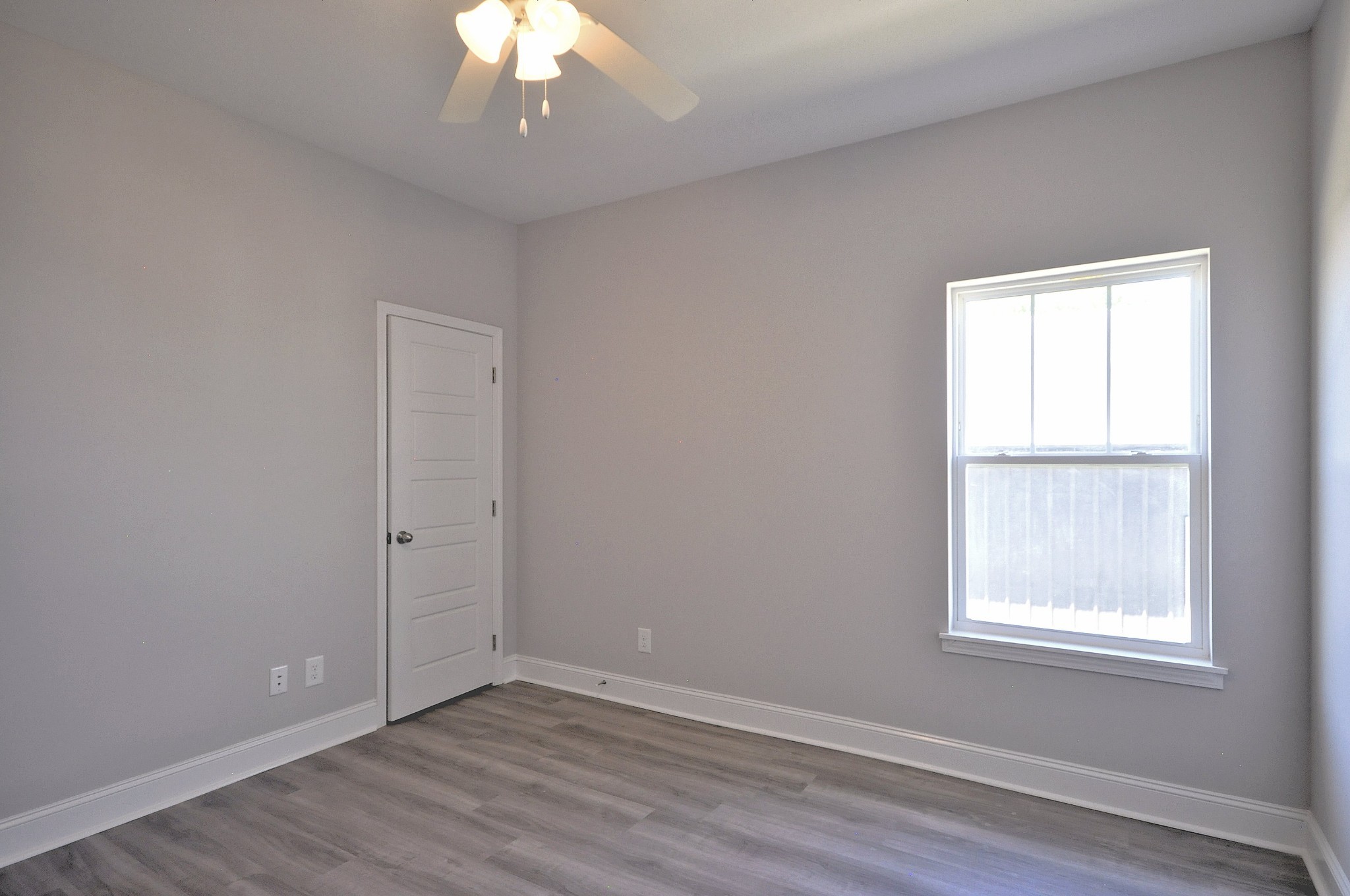 179 Bainbridge Drive, Unit A Clarksville, TN 37043 - Photo 21 of 33 an empty room with wooden floor chandelier and window