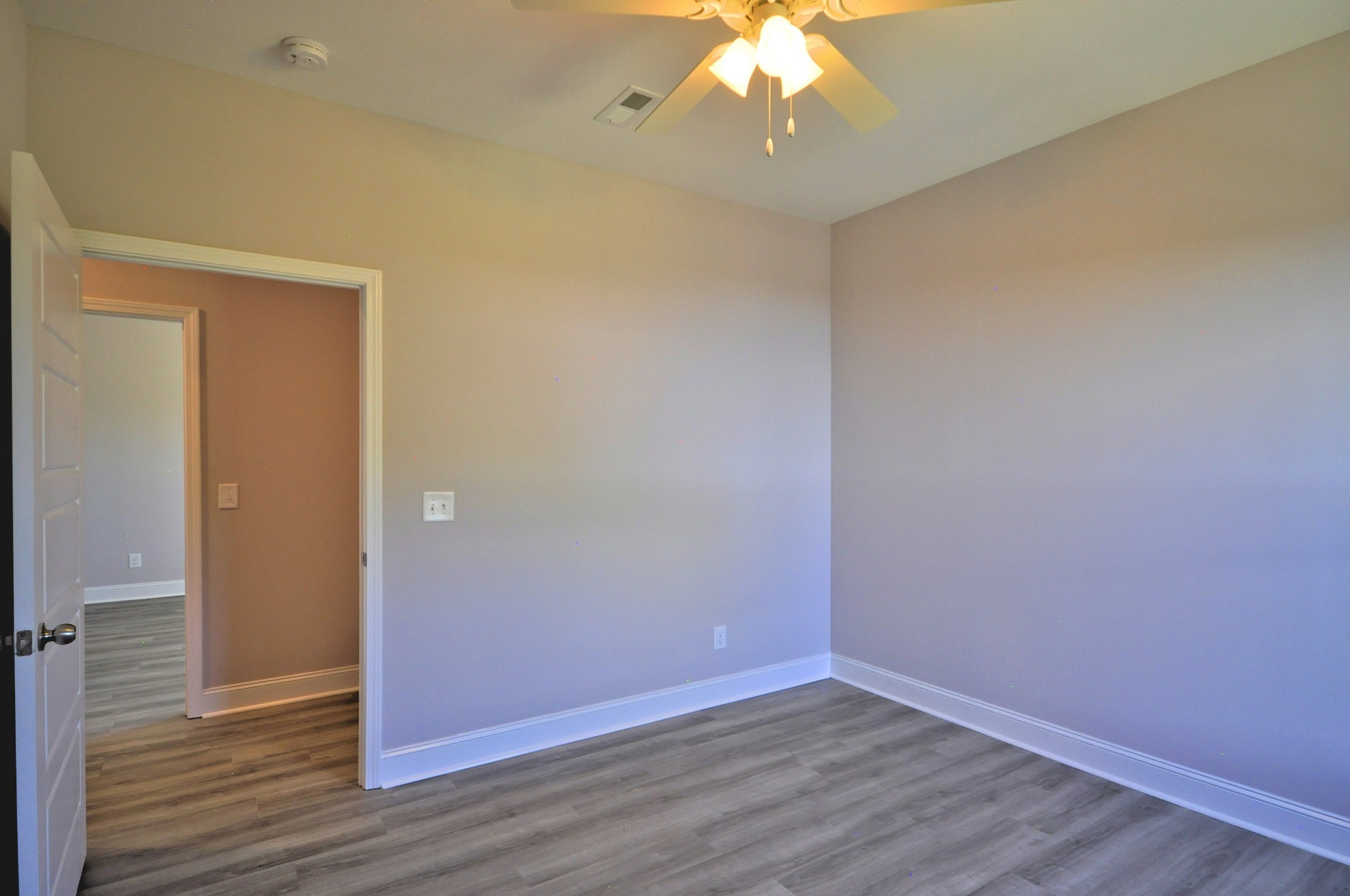 179 Bainbridge Drive, Unit A Clarksville, TN 37043 - Photo 23 of 33 an empty room with wooden floor and chandelier fan