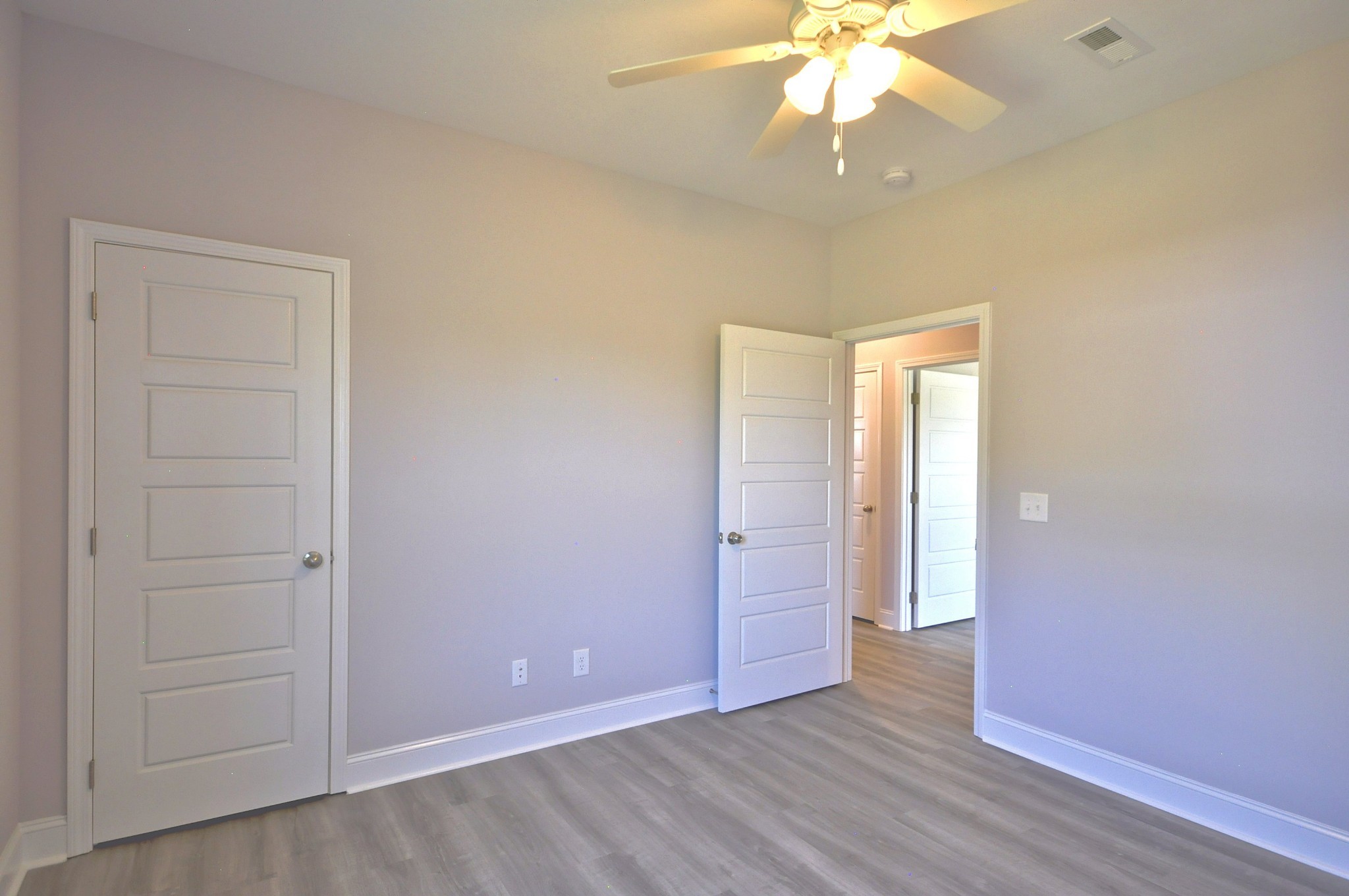 179 Bainbridge Drive, Unit A Clarksville, TN 37043 - Photo 24 of 33 an empty room with wooden floor fan and window
