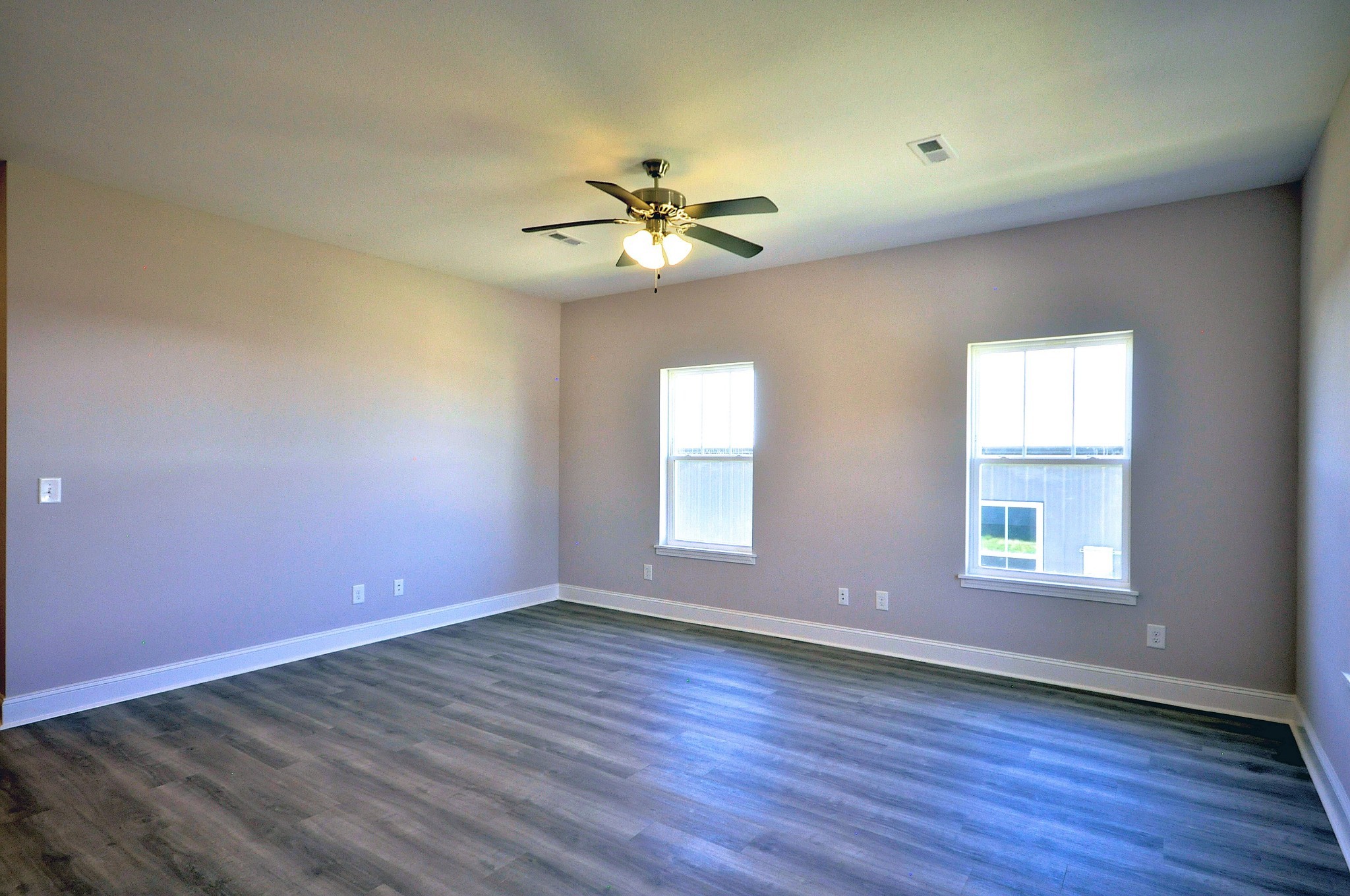 179 Bainbridge Drive, Unit A Clarksville, TN 37043 - Photo 4 of 33 an empty room with wooden floor chandelier fan and windows