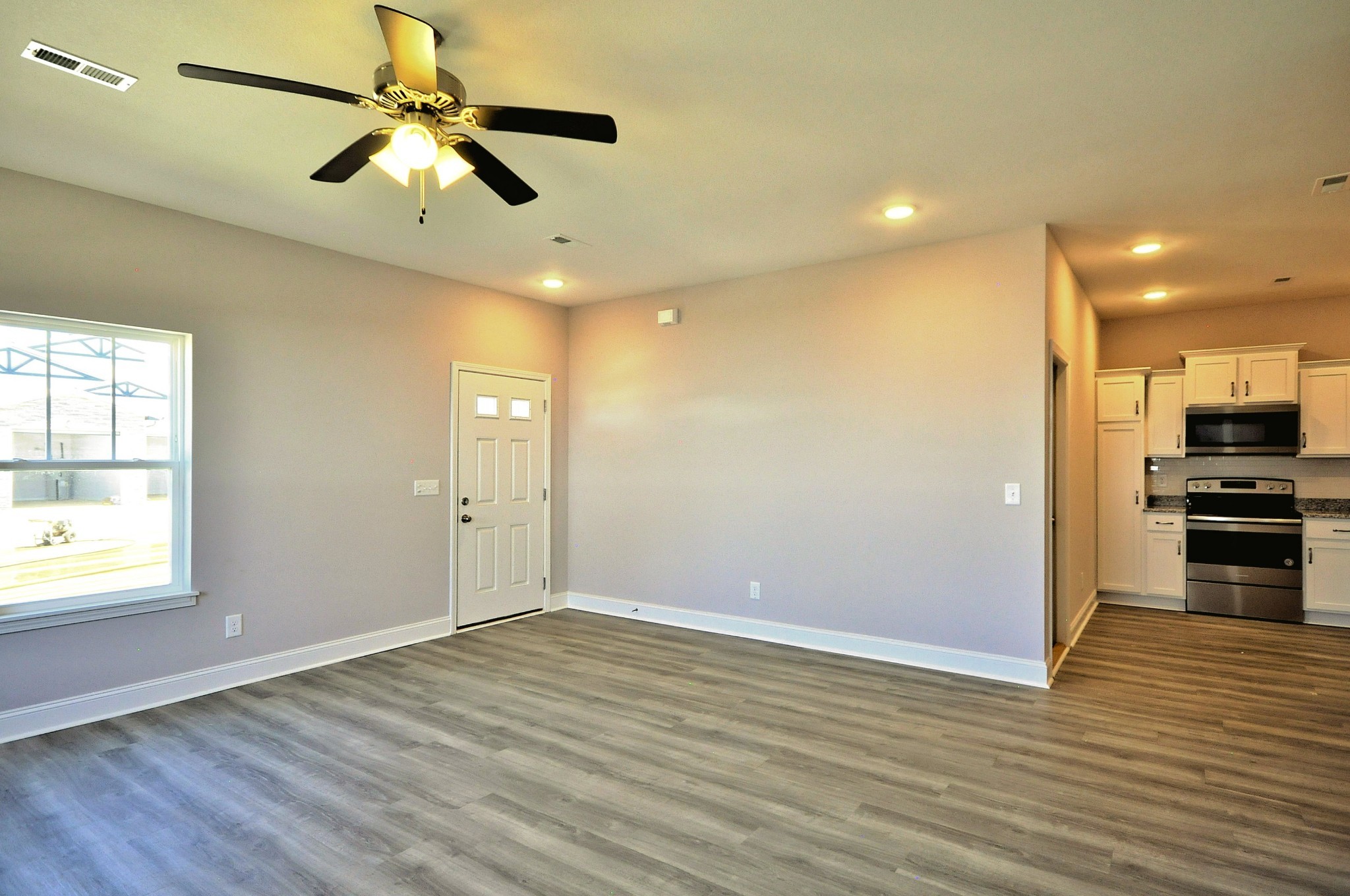 179 Bainbridge Drive, Unit A Clarksville, TN 37043 - Photo 5 of 33 an empty room with wooden floor and a ceiling fan