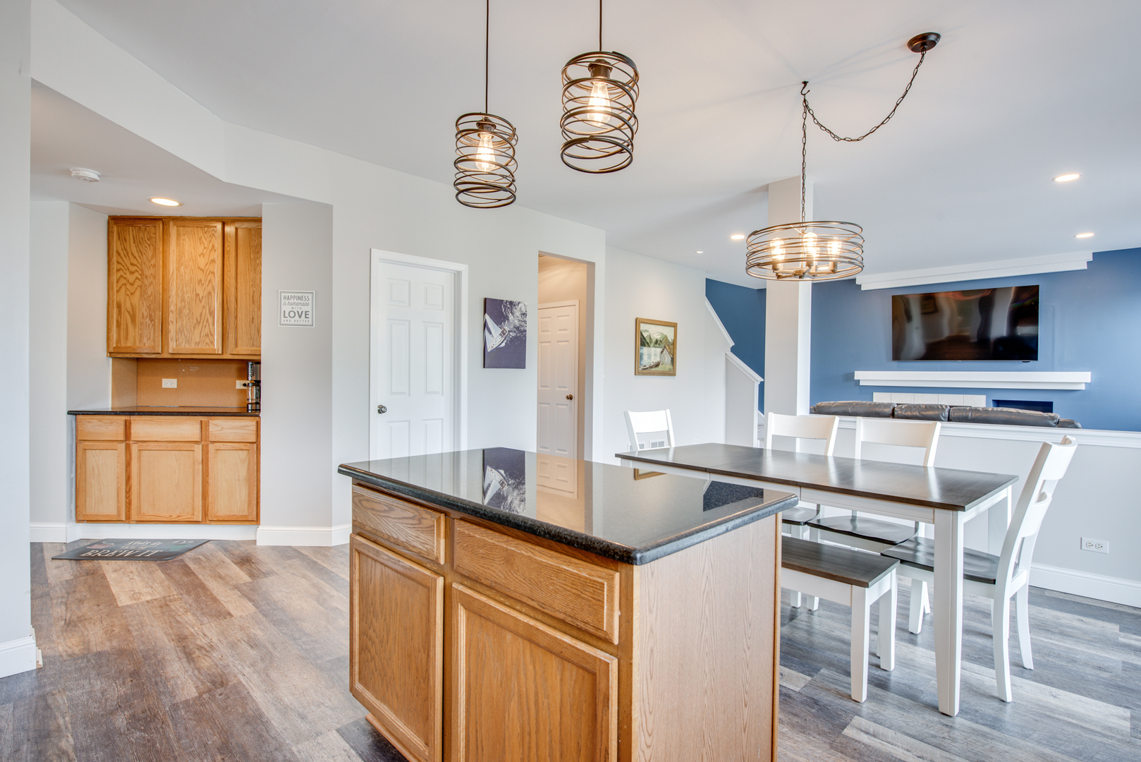 416 Hubbard Circle Plano, IL 60545 - Photo 11 of 57 a kitchen with kitchen island granite countertop a stove a sink and a wooden floors