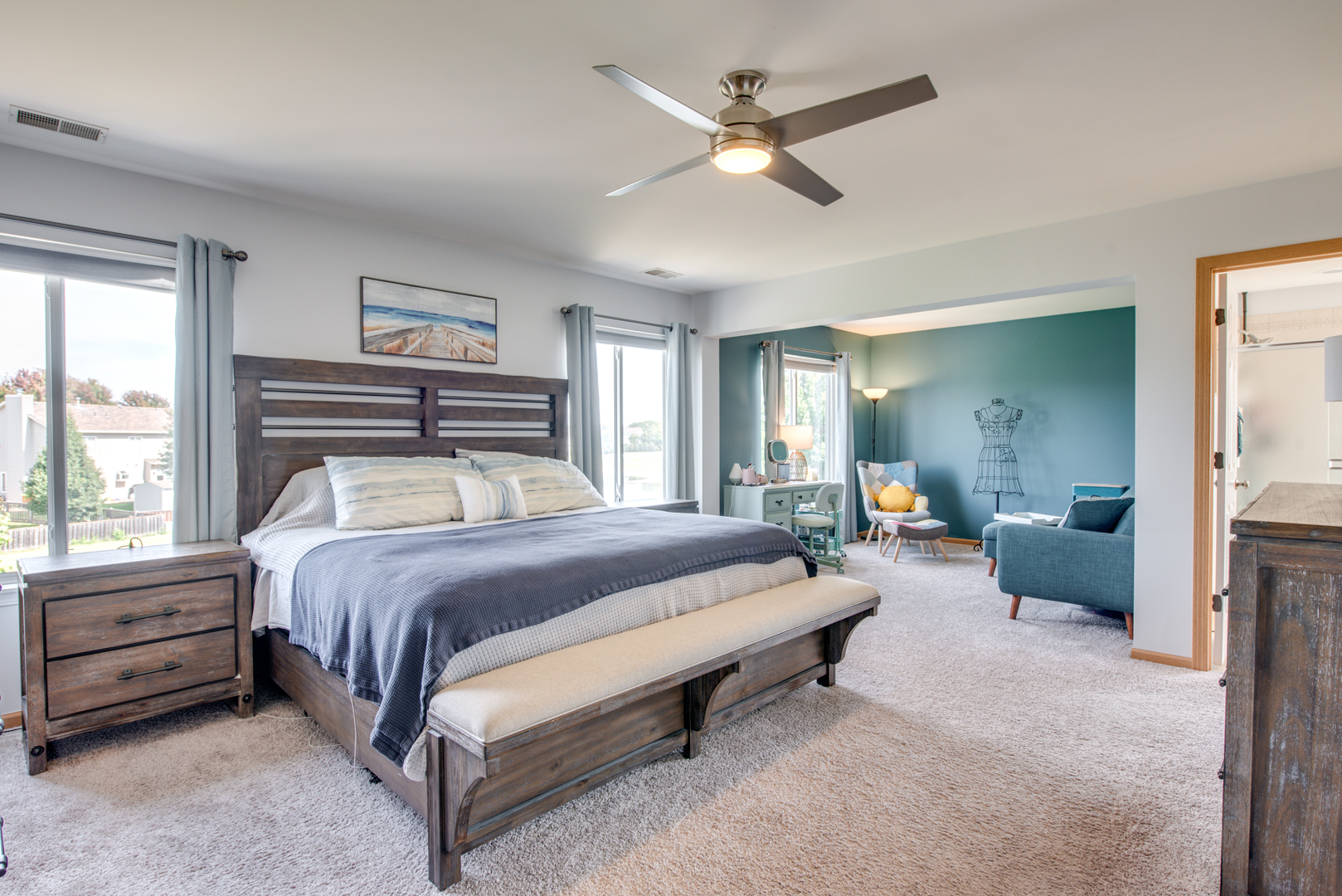 416 Hubbard Circle Plano, IL 60545 - Photo 16 of 57 a bedroom with a bed a chandelier and a couch