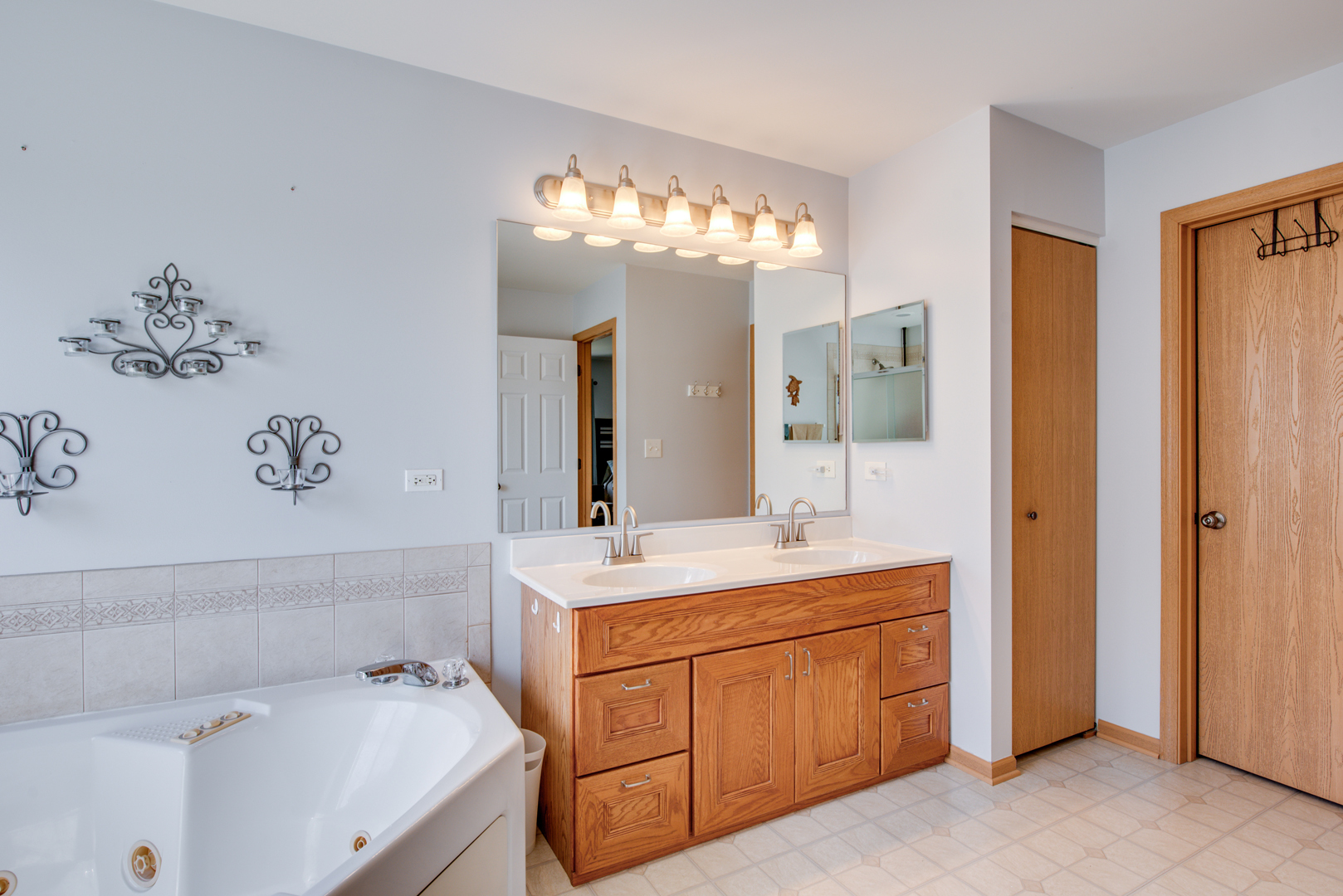 416 Hubbard Circle Plano, IL 60545 - Photo 20 of 57 a bathroom with a sink double vanity granite tub shower and a mirror