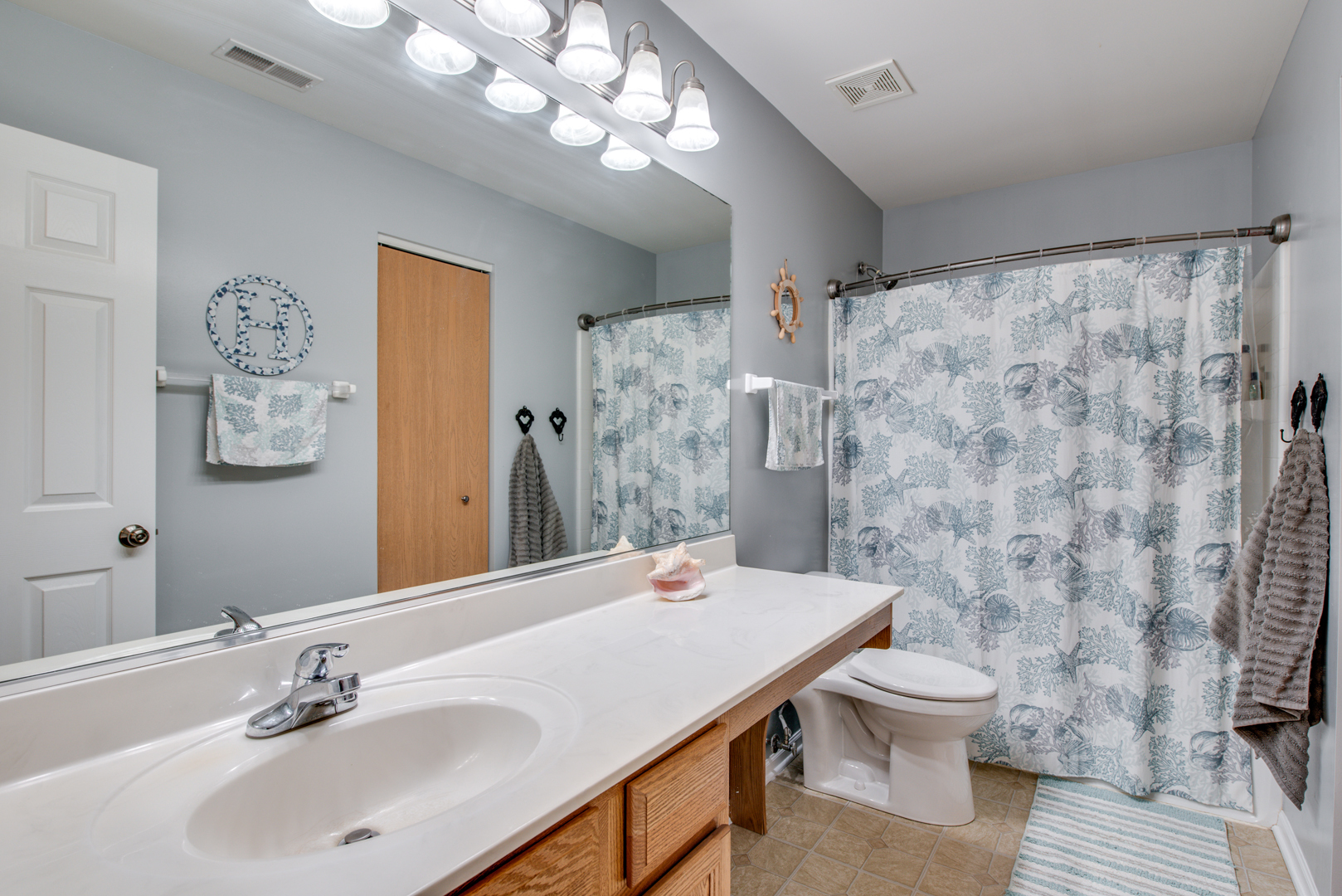 416 Hubbard Circle Plano, IL 60545 - Photo 24 of 57 a bathroom with a sink a toilet and shower curtain
