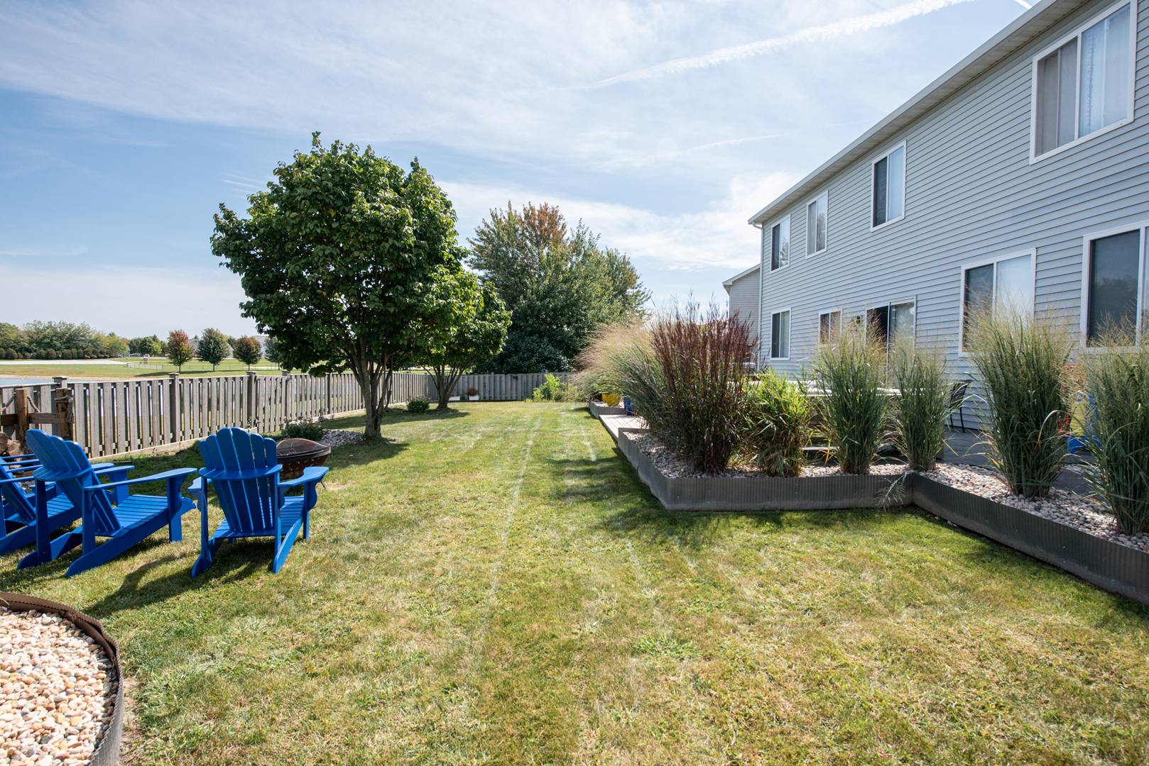 416 Hubbard Circle Plano, IL 60545 - Photo 33 of 57 a view of a swimming pool with a patio and a garden