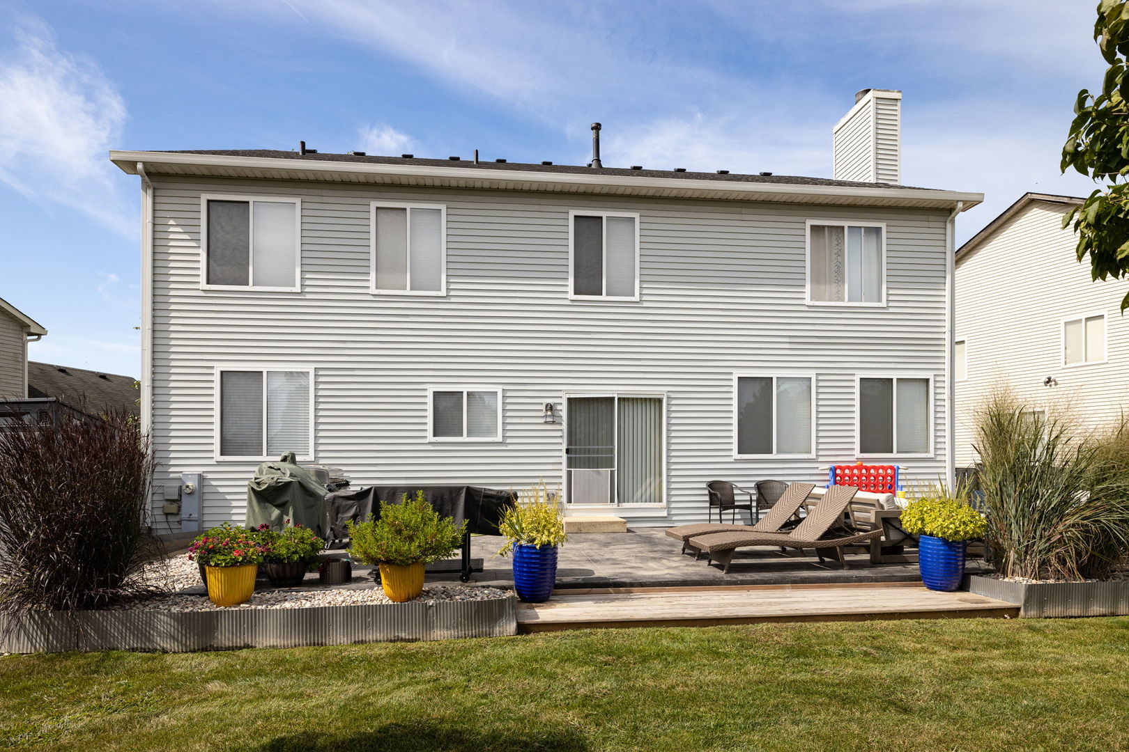 416 Hubbard Circle Plano, IL 60545 - Photo 42 of 57 a view of a house with patio chairs and a table