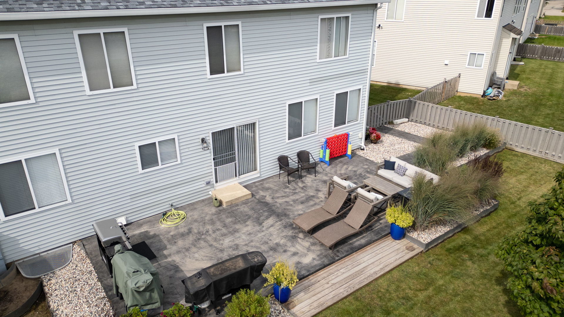 416 Hubbard Circle Plano, IL 60545 - Photo 49 of 57 a view of a patio that has couches chairs with wooden floor