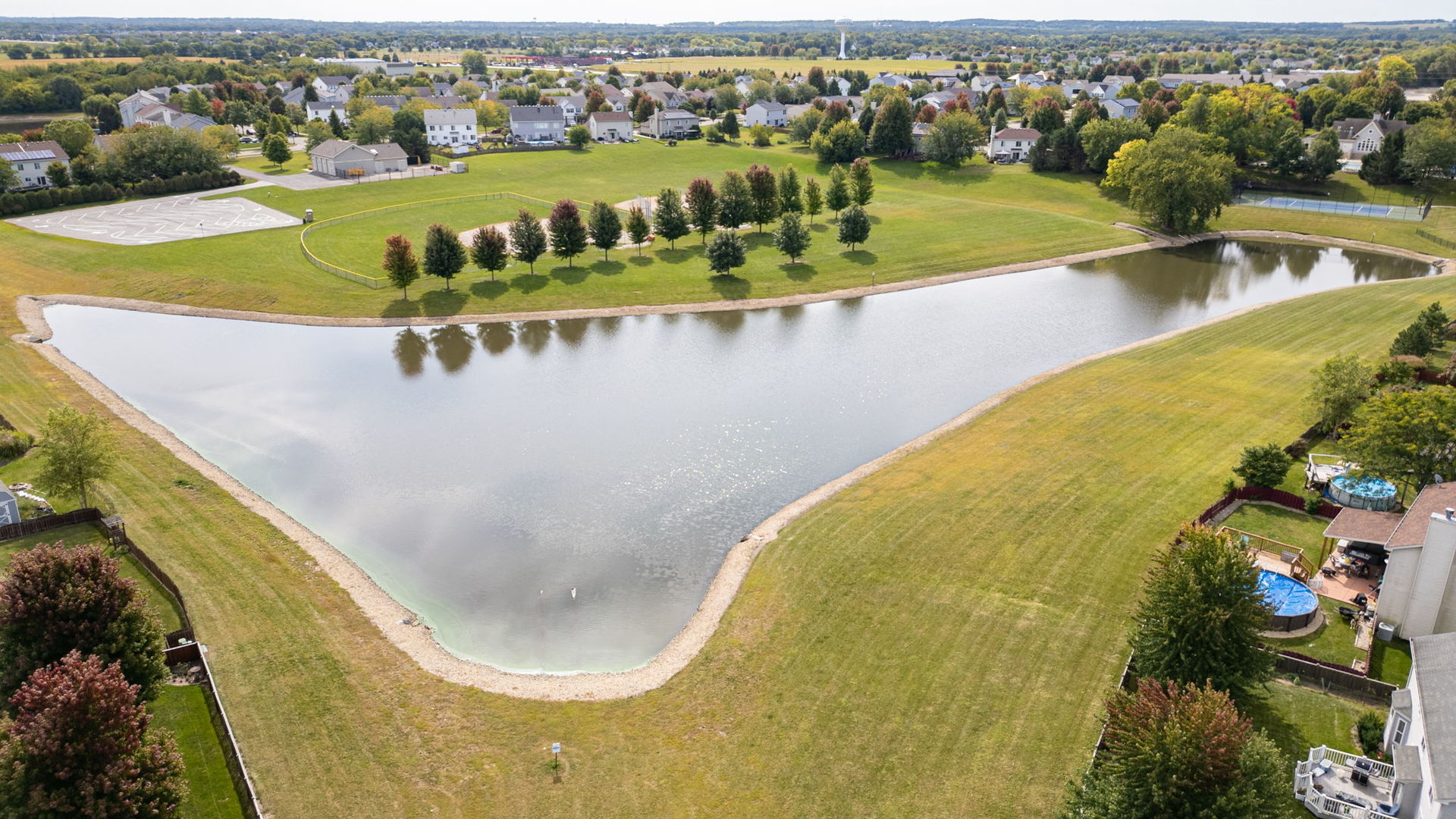416 Hubbard Circle Plano, IL 60545 - Photo 51 of 57 a view of a swimming pool with a lawn chairs