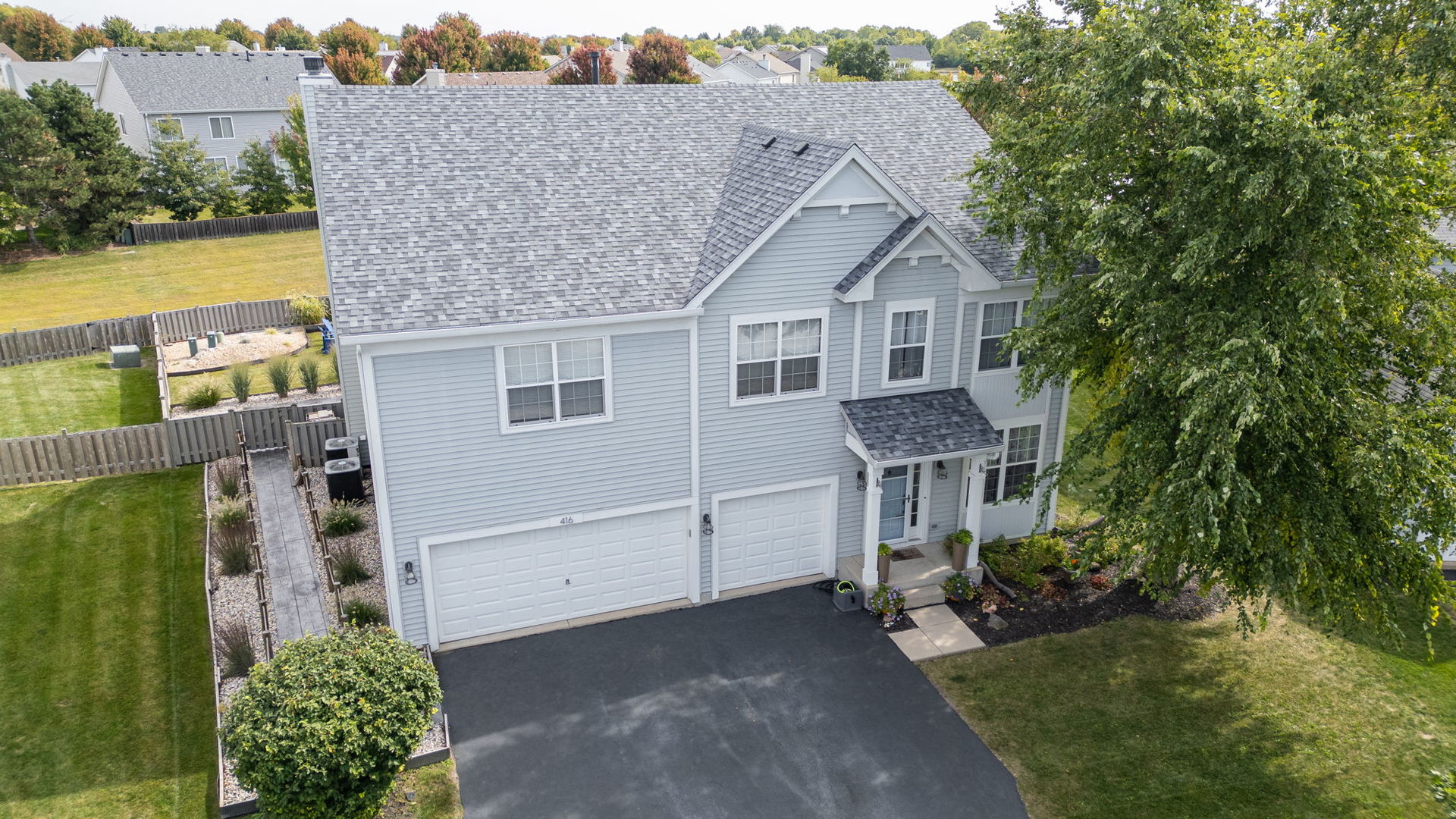 416 Hubbard Circle Plano, IL 60545 - Photo 55 of 57 a front view of a house with garden