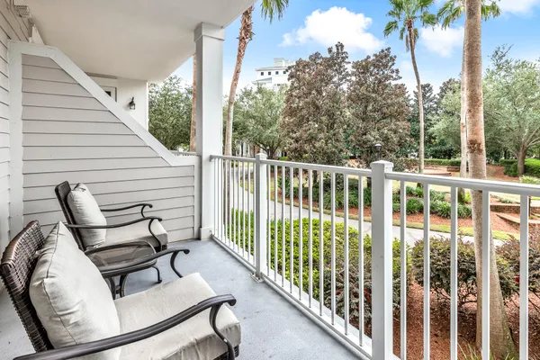a view of a chair and tables in the balcony