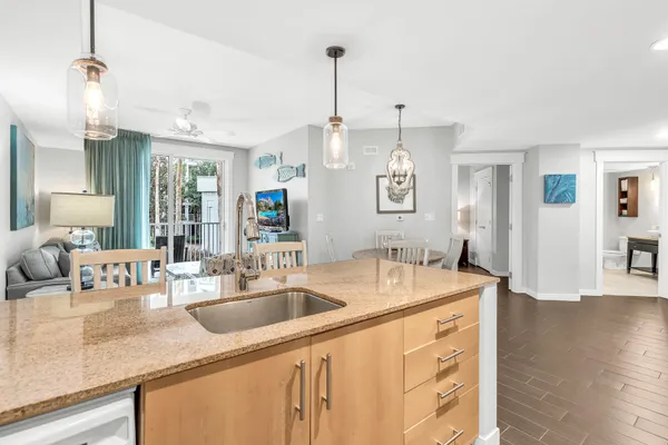 a kitchen with sink refrigerator and microwave