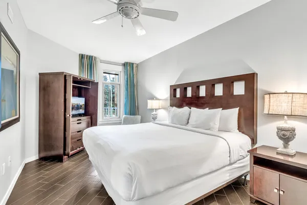 a bedroom with a large bed and a chandelier