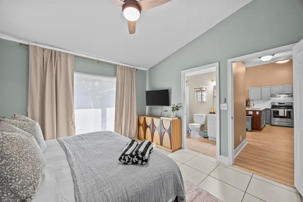 a bedroom with a bed and a flat screen tv