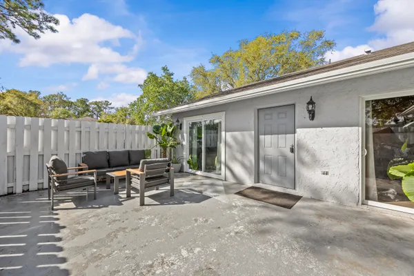 a view of backyard with outdoor seating and plants