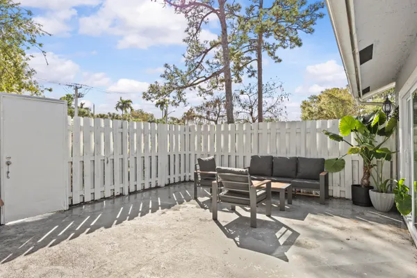 a view of backyard with outdoor seating a patio and plants