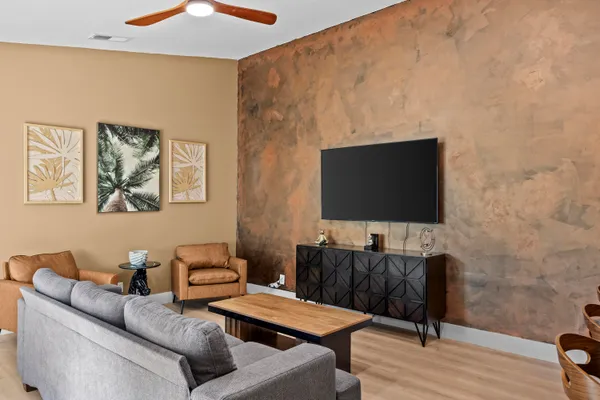 a living room with furniture and a flat screen tv