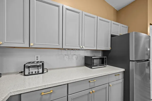 a kitchen with appliances cabinets and a counter top space