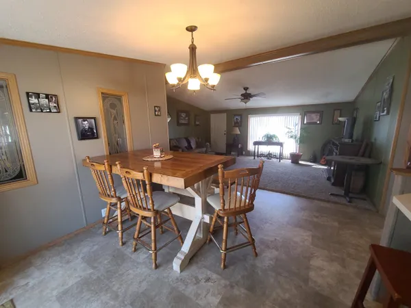 a view of a dining room with furniture and a chandelier