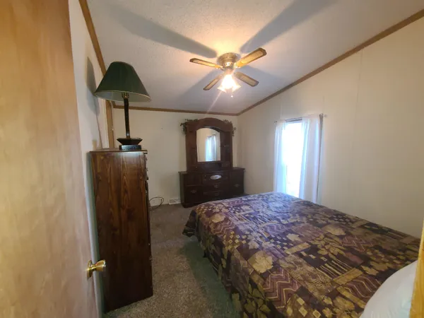 a bedroom with a bed and a chandelier