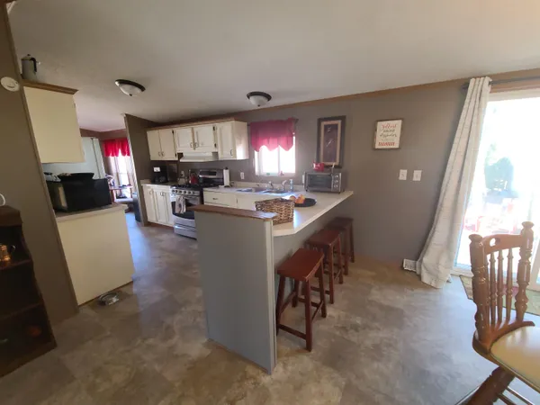 a kitchen that has a lot of cabinets a sink and appliances in it