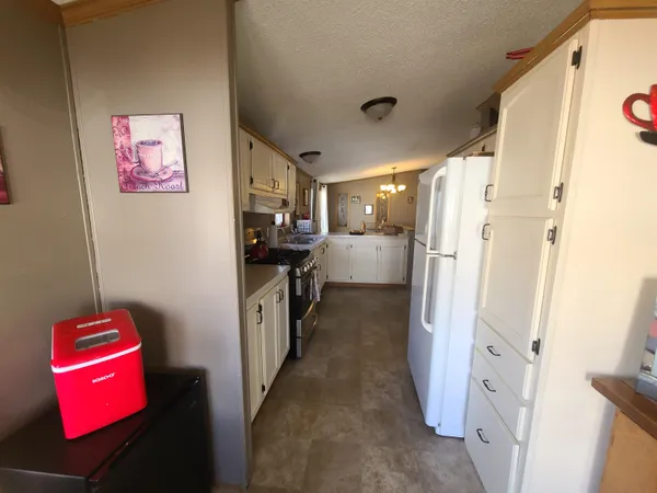 a kitchen with refrigerator a stove top oven a refrigerator and dishwasher