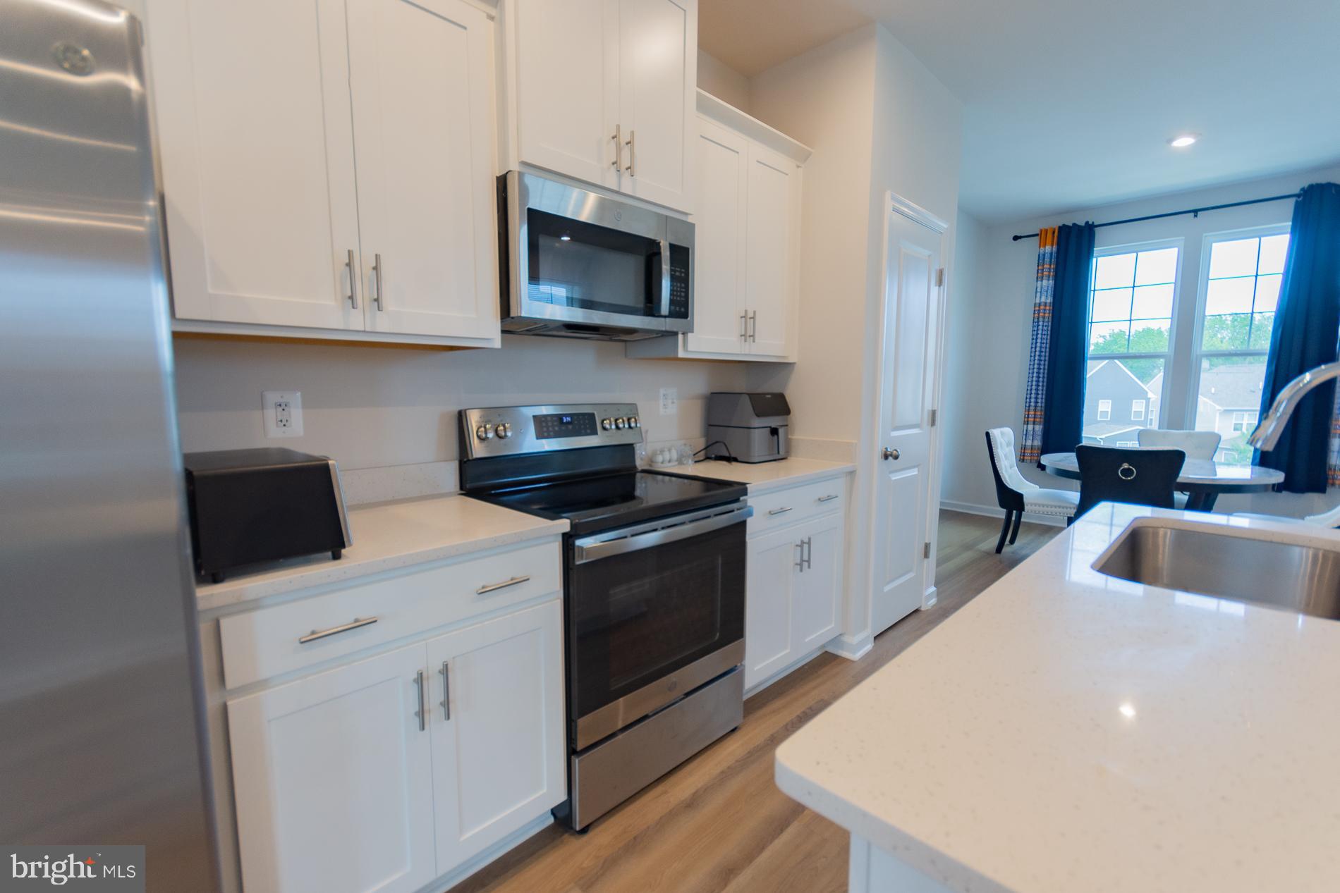 50 Coolidge Avenue Ranson, WV 25438 - Photo 11 of 47 a kitchen with white cabinets and sink