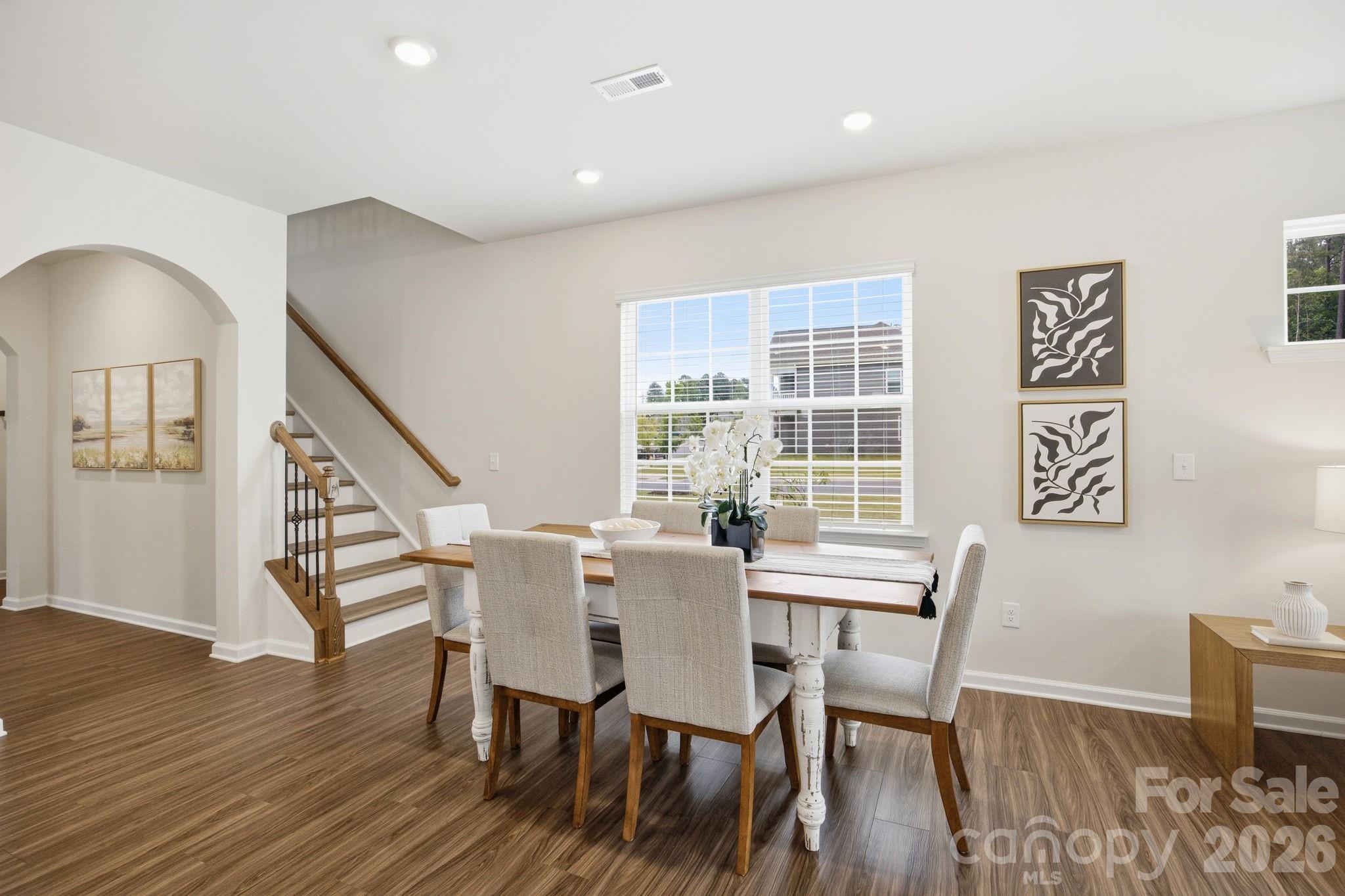 234 Hamptons Cove Road Troutman, NC 28166 - Photo 11 of 32 a view of a dining room with furniture window and wooden floor