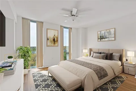 a bedroom with a large bed and a chandelier