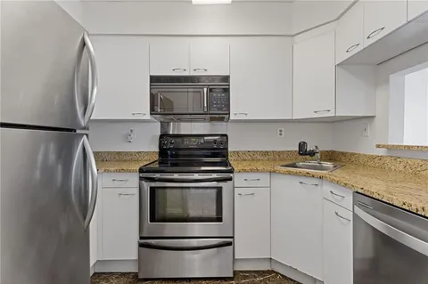 a kitchen with a stove and a refrigerator