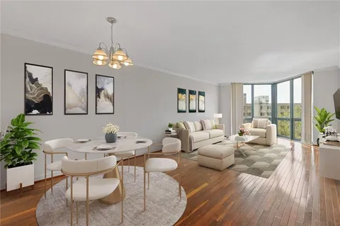 a living room with furniture chandelier and a wooden floor