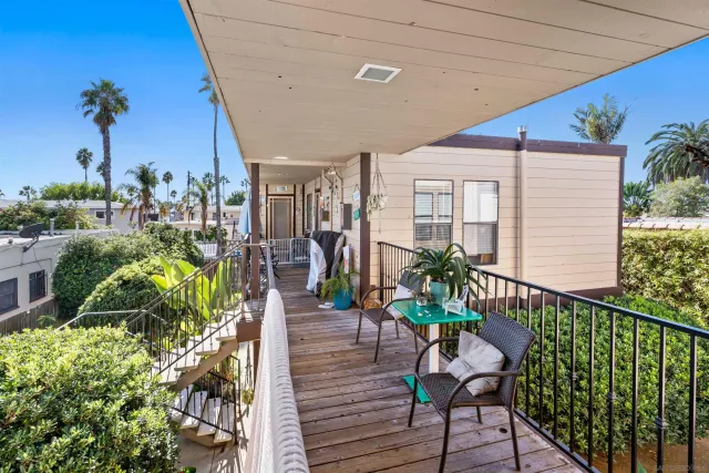 a view of a porch with chairs and potted plants