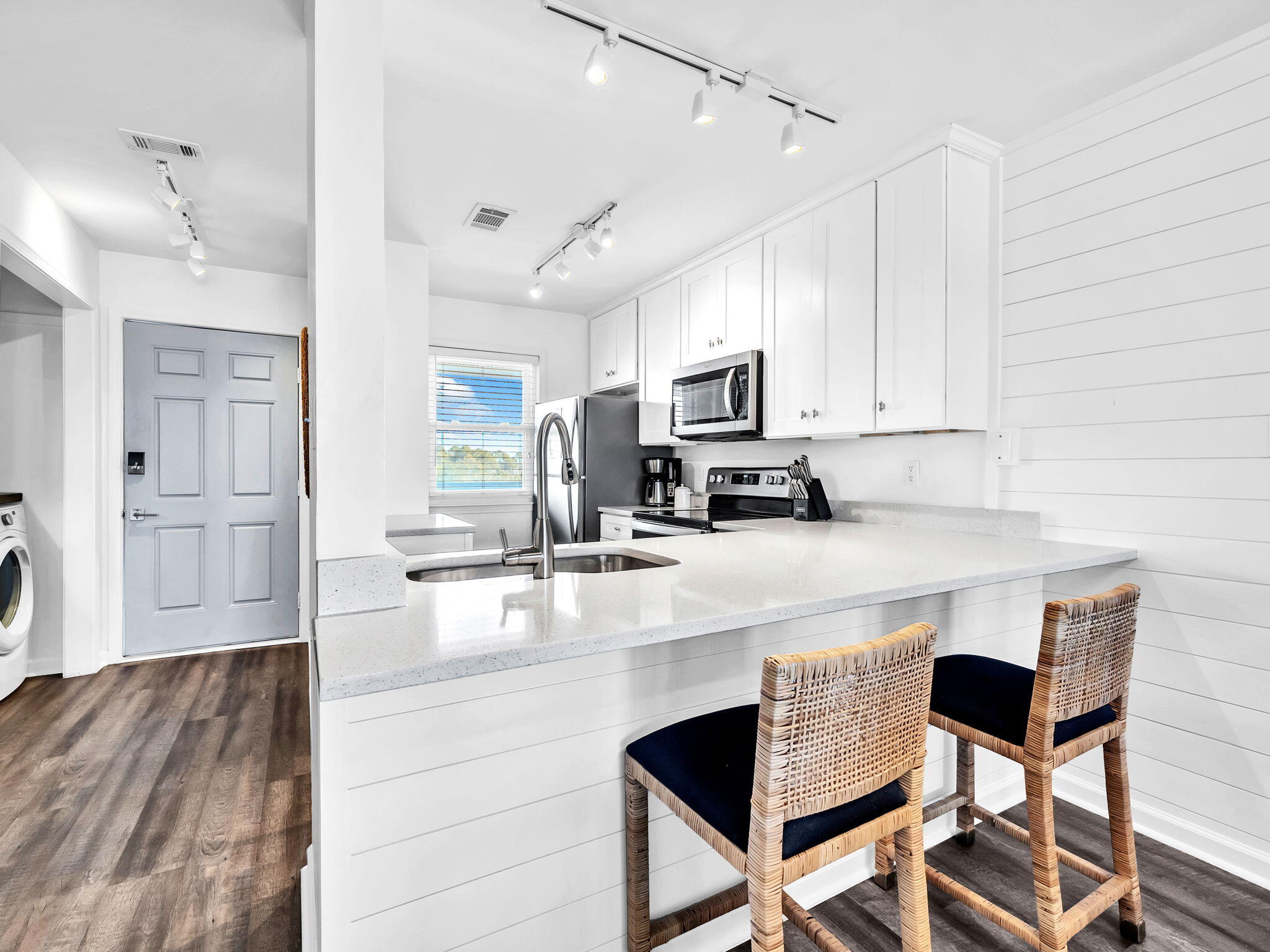 23011 Front Beach Road, Unit W42 Panama City Beach, FL 32413 - Photo 8 of 30 a kitchen with granite countertop white cabinets and stainless steel appliances