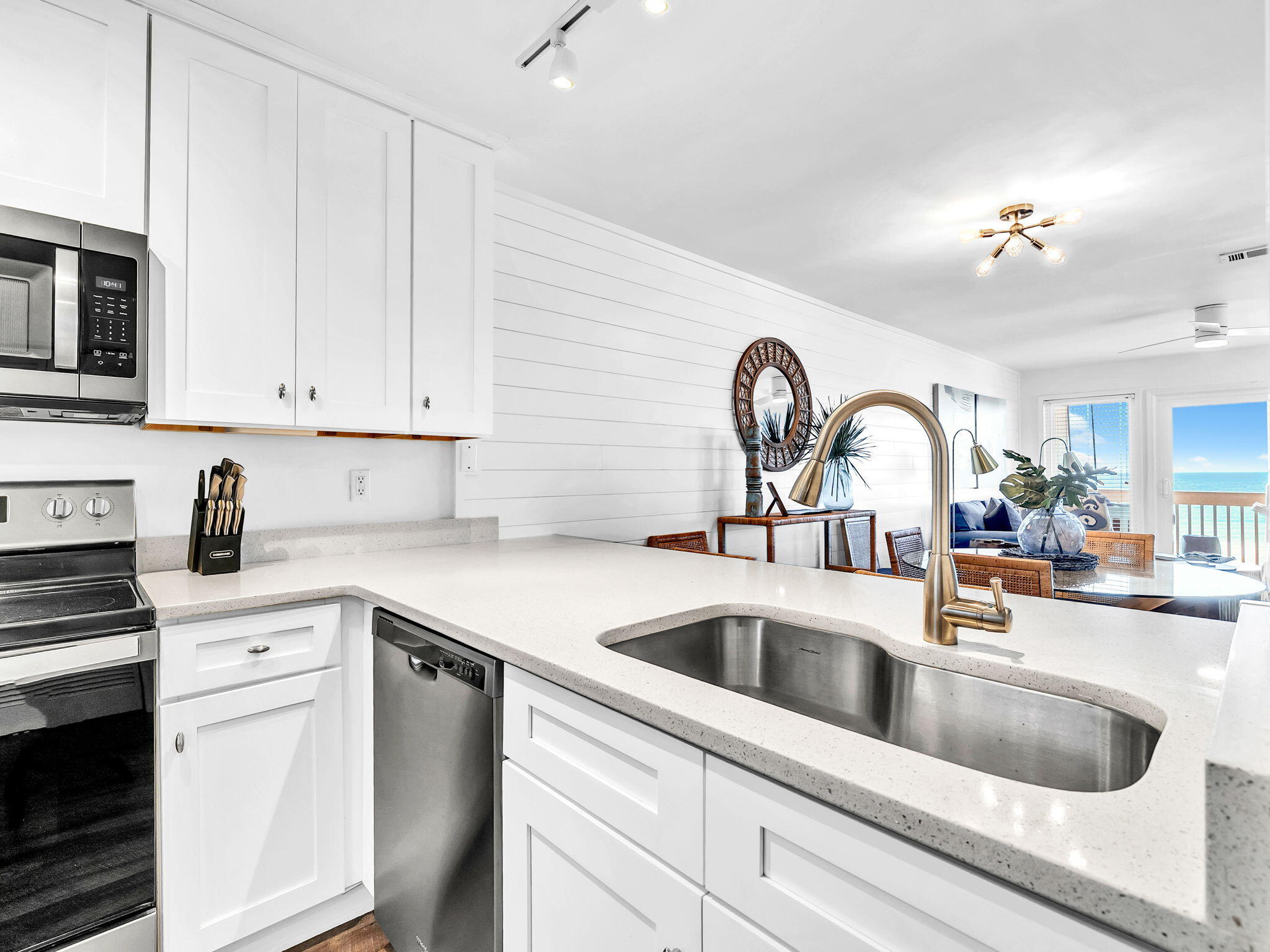 23011 Front Beach Road, Unit W42 Panama City Beach, FL 32413 - Photo 9 of 30 a kitchen with a sink cabinets and appliances