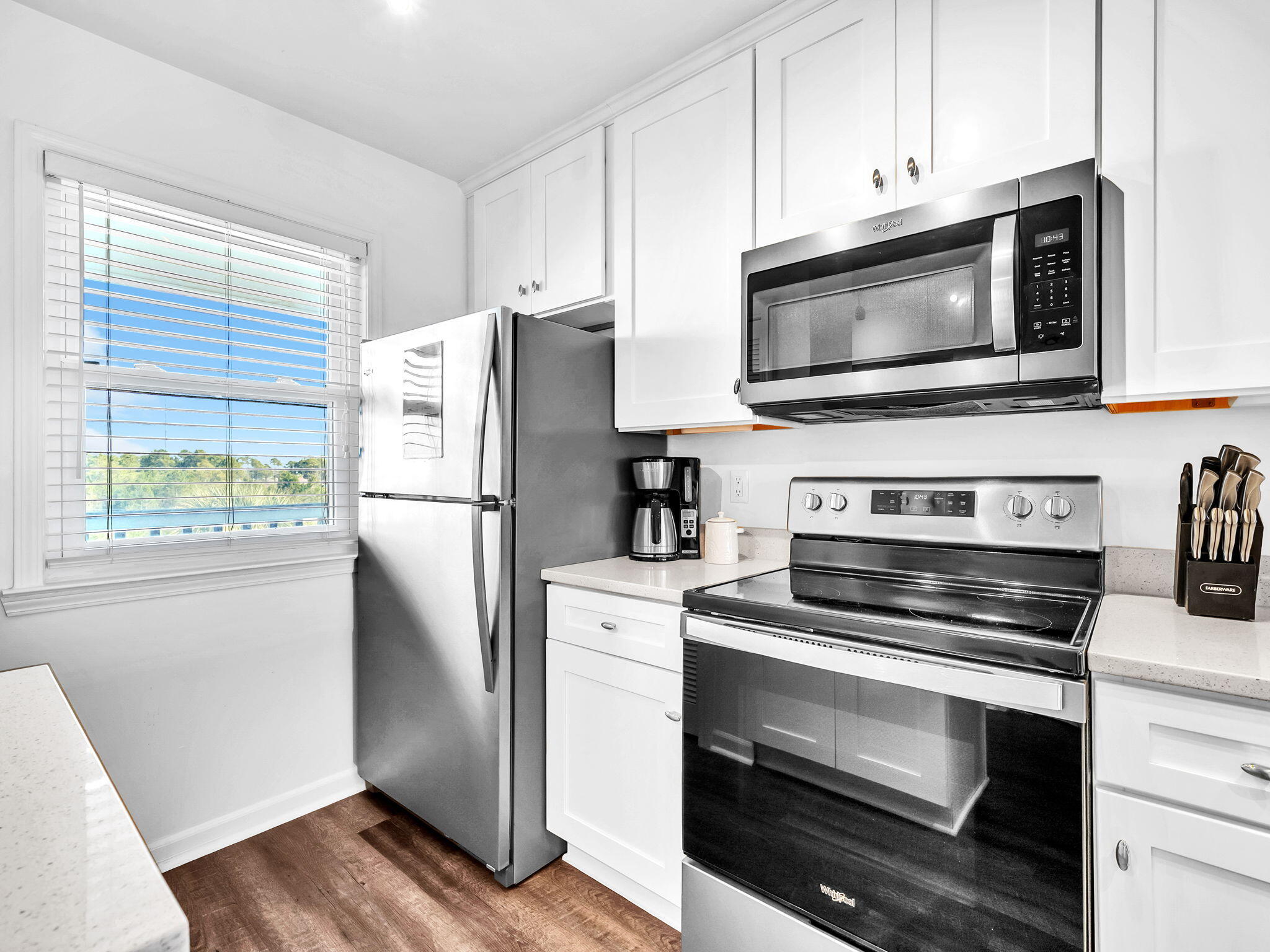 23011 Front Beach Road, Unit W42 Panama City Beach, FL 32413 - Photo 10 of 30 a kitchen with stainless steel appliances a stove microwave and refrigerator
