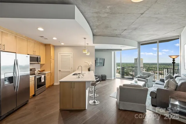 a kitchen with stainless steel appliances granite countertop a sink a stove and a refrigerator