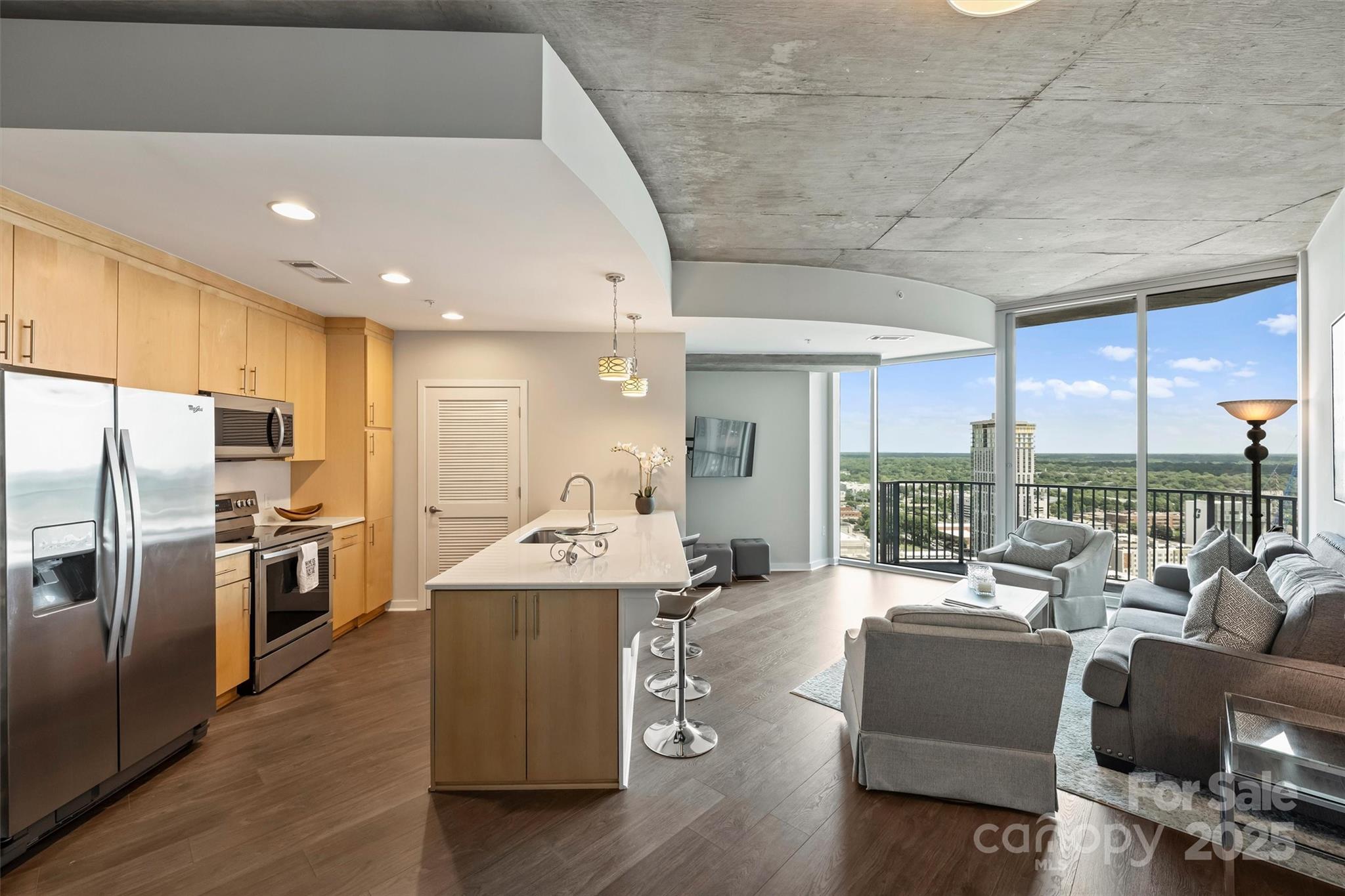 a kitchen with stainless steel appliances granite countertop a sink a stove and a refrigerator